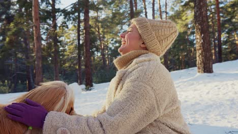 woman and her dog in a snowy forest