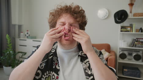 speech coach rubbing face and explaining articulation technique to camera