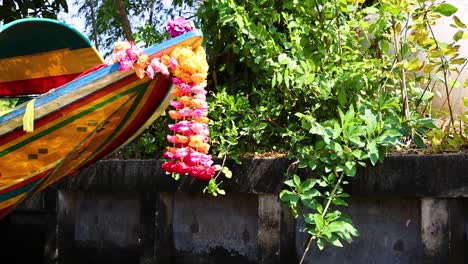 colorful thai boat decorated with flowers in canal