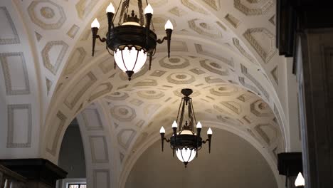 gradual pan across a room's ornate ceiling and lights