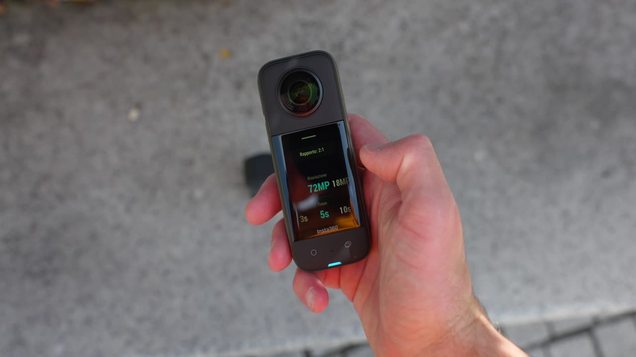 360 camera being set up by a person's hand