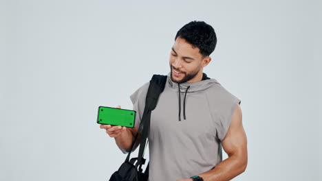 Fit-man,-phone-and-pointing-to-green-screen