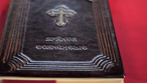 handheld shot of the holy book on a table