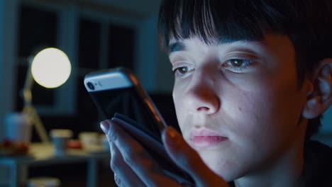 teenager using a smartphone at night
