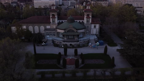 Aerial-fly-over-of-a-renaissance-building-in-Lausanne,-Switzerland-at-dusk