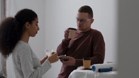 young couple taking a break during home renovation