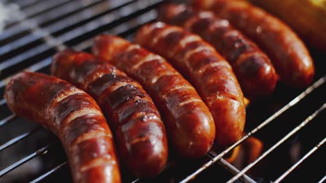 Tasty-juicy-sausages-grilling-over-a-fire