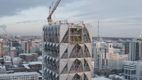 modern skyscraper under construction in a city