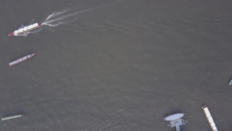 aerial view of river boats and piers in a city