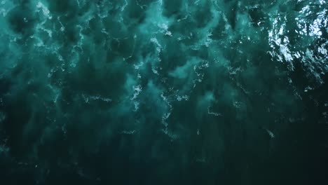 aerial footage above the dark, murky, and rough waters found on the north shore coast of oahu, hawaii