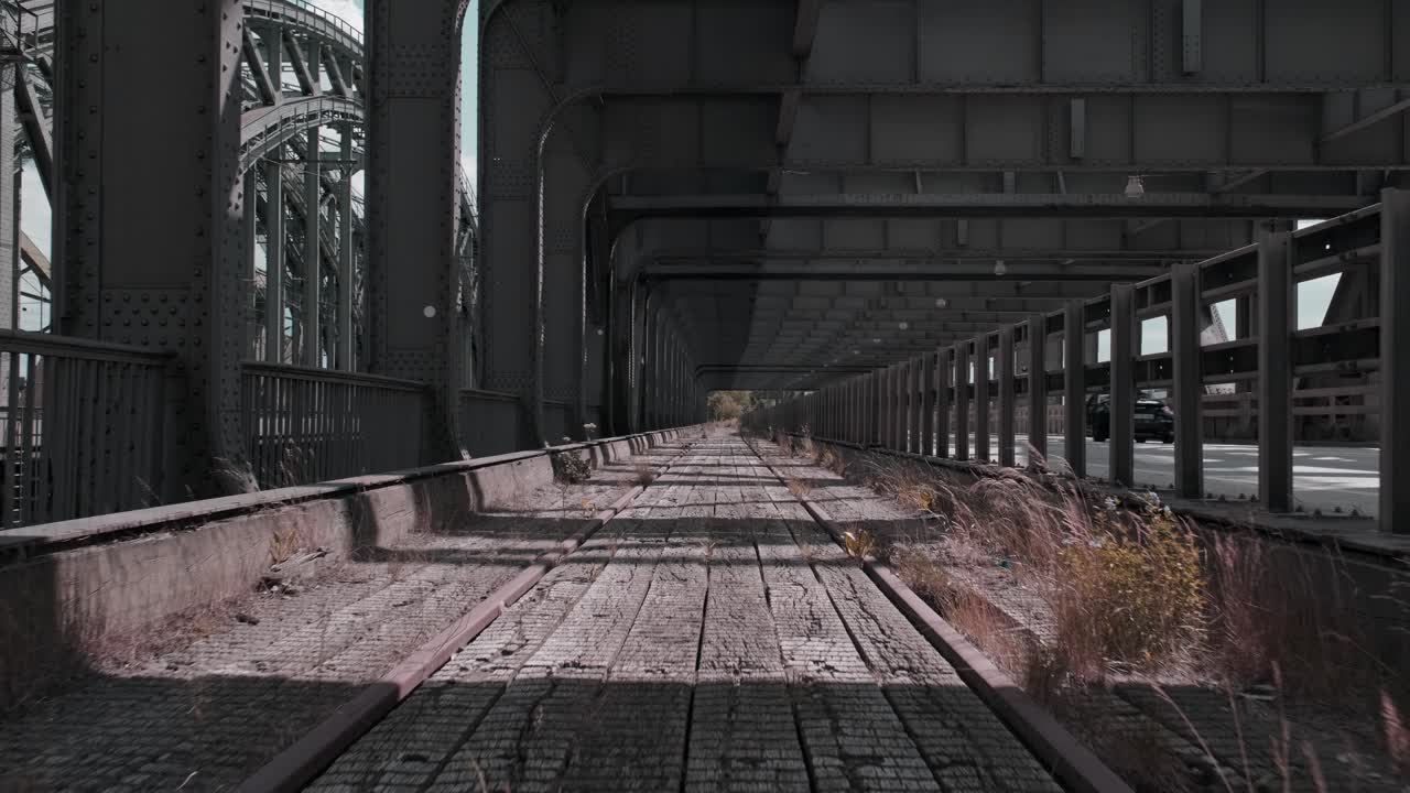 Abandoned Railway Tracks Under an Industrial Bridge