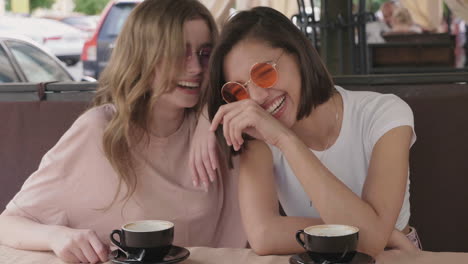 two friends laughing over coffee