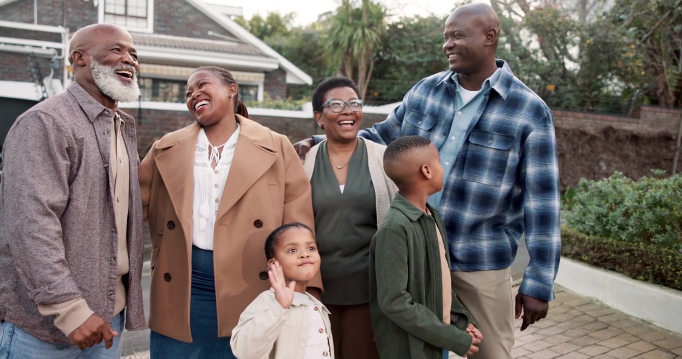 Multi-Generational Family Standing Together Outside Their Home