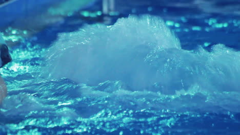 water splashes in jacuzzi. rippled water in blue swimming pool