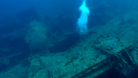 bubbles emerge from vertical shaft on the bow of deep shipwreck