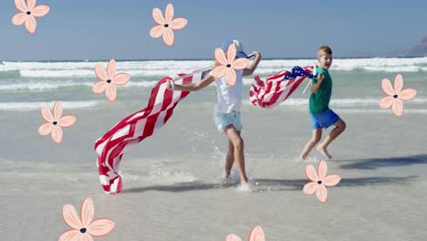 Animation-Fallender-Blumen-über-Kindern,-Die-US-Flaggen-Am-Strand-Halten