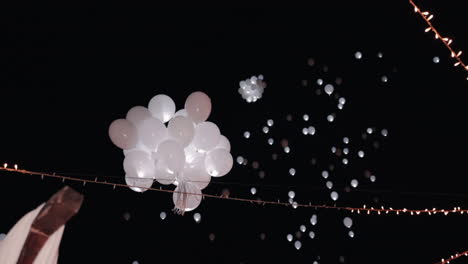 balloons and fairy lights in night celebration