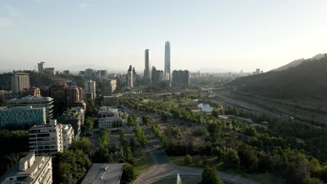 Aerial-view-of-the-financial-district-of-the-city-of-Santiago-de-Chile-with-the-sunset-on-the-horizon---drone-shot