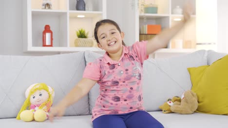 cheerful girl child dancing at home and feeling happy.