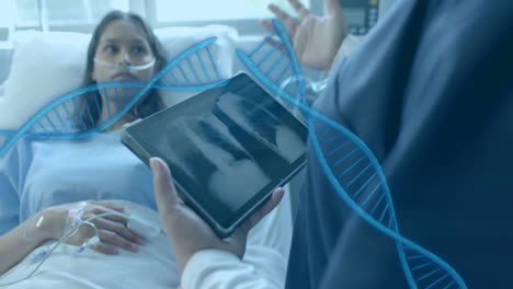 animation of dna strands over diverse female doctor with tablet and patient in hospital