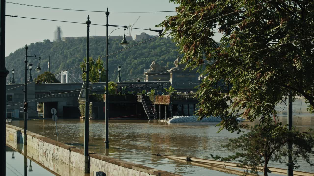Flooded street with water near tram tracks, Budapest Flood 2024, daytime scene
