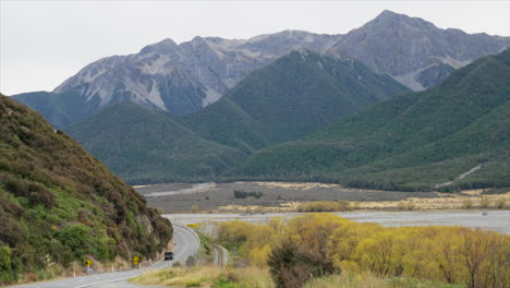 black 4wd driving along the state highway through arthurs pass, new zealand