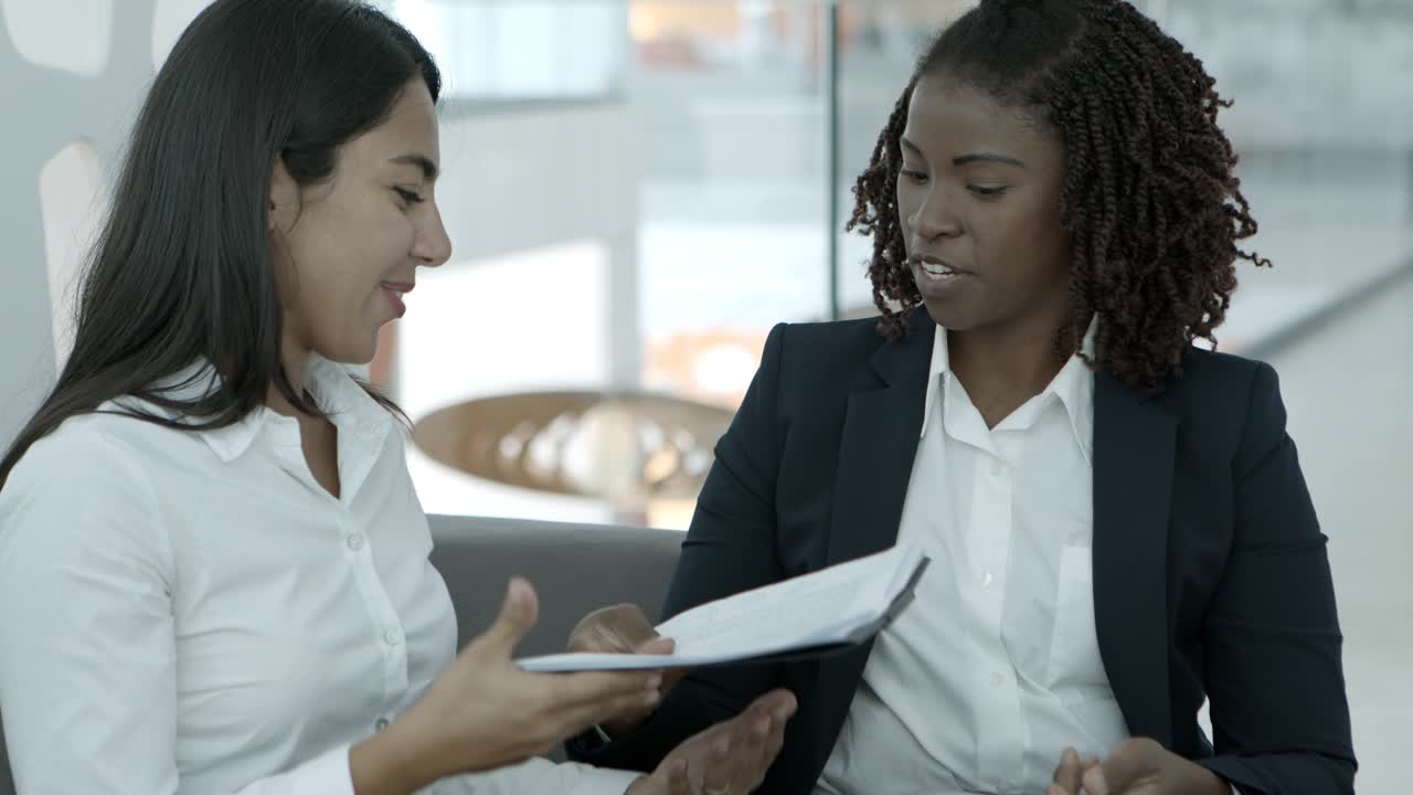 Smiling businesswomen shaking hands