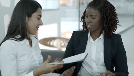 smiling businesswomen shaking hands