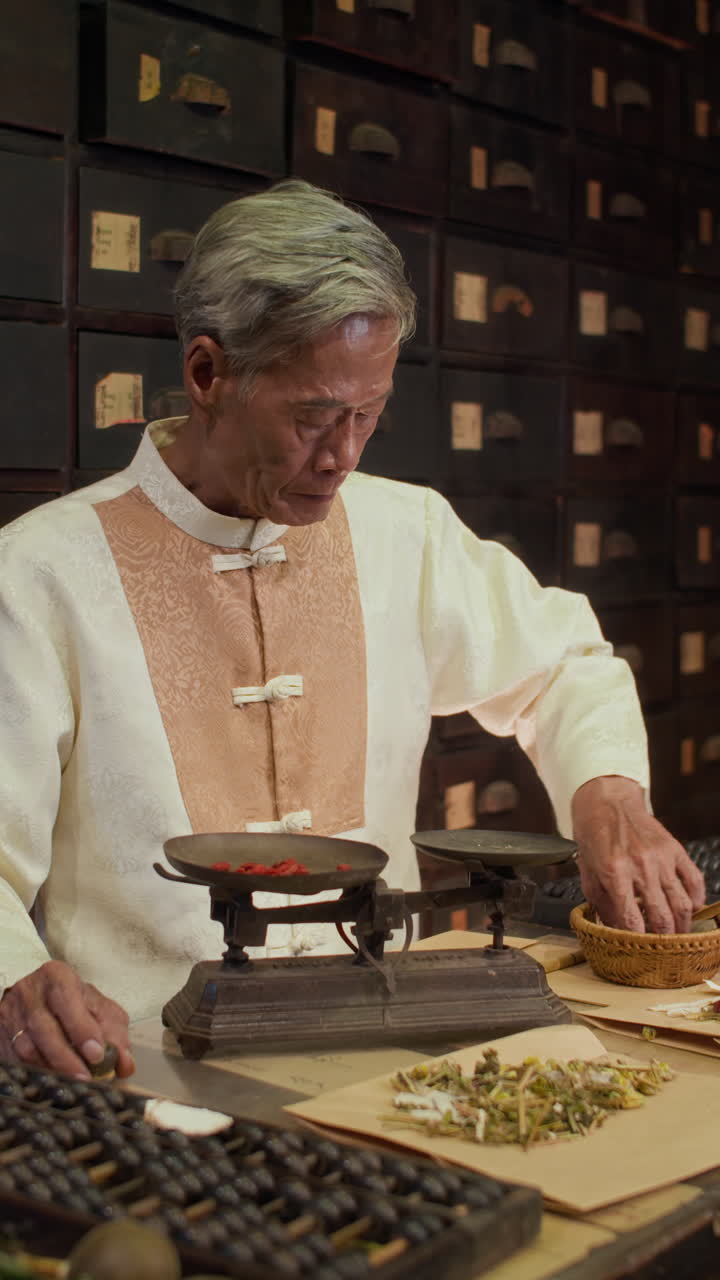 Elderly Herbalist Measuring Ingredients on Scales