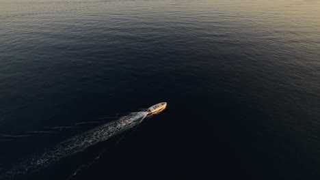 droneshot of delta speedboat riding in the sunset