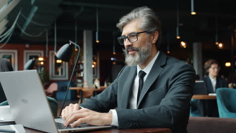 businessman working on laptop in cafe