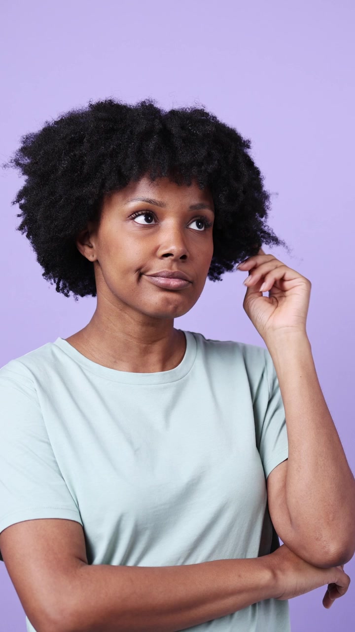 Thoughtful Young Black Woman Pondering with Afro Hair