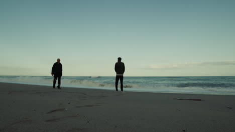 celebrating father's day with son on the beach near the sea at sunset