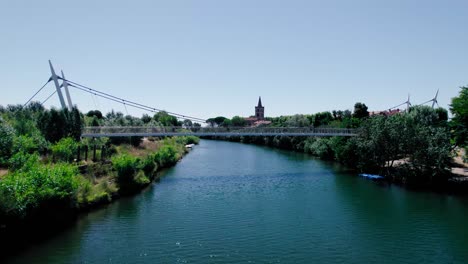 aerial shot underneath a bridge with a rising shot of