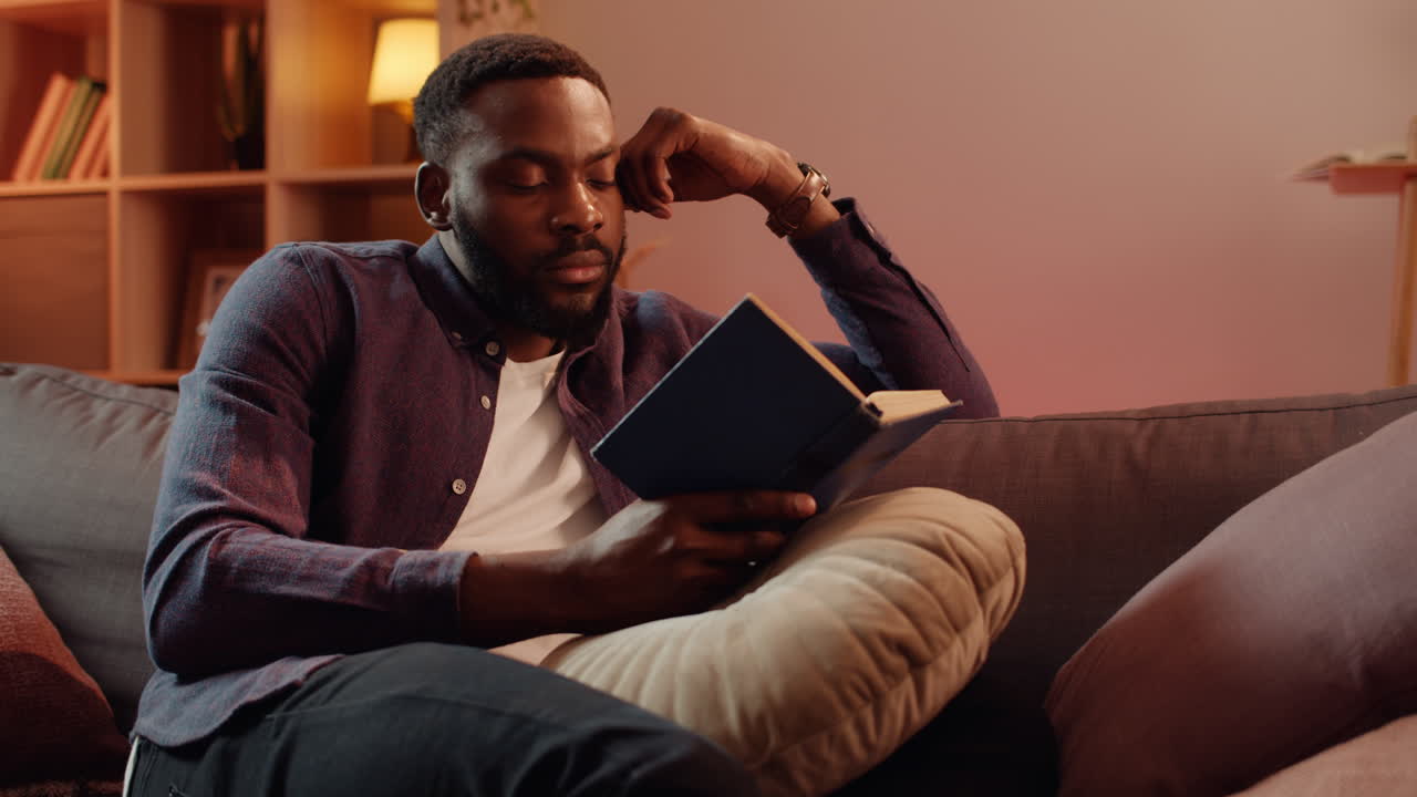 Man reading a book at home