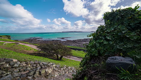 Hyper-lapse-of-family-walking-through-waterfront-footpath-sea-in-Guernsey