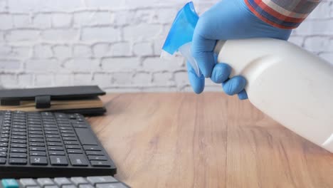 cleaning a workstation with disinfectant spray