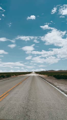 empty desert highway under a cloudy sky