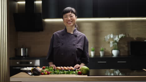 asian woman chef preparing sushi in a modern kitchen