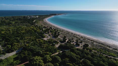 Aerial-drone-forward-moving-shot-over-green-vegetation-along-Coogee-Beach-Jetty-in-Perth,-Western-Australia-during-evening-time