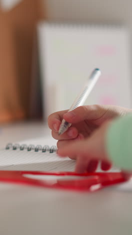 girl pupil draws geometrical figure with triangular ruler and pen at desk closeup. smart schoolgirl does mathematics homework with supplies at home