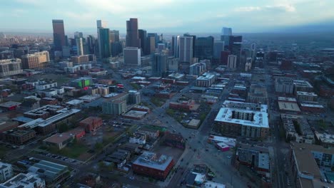 rhino downtown denver cityscape city tall skyscraper buildings aerial drone colorado spring summer afternoon sunset mountains range landscape stormy clouds sunny panorama forward pan up motion