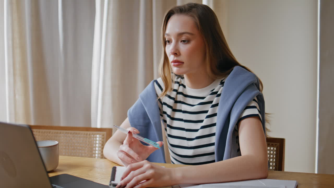 Student making online research at laptop in apartment closeup. Woman working