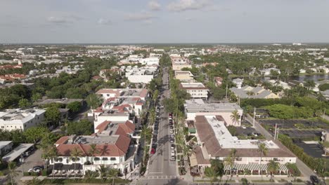 aerial follows quiet palm lined fifth ave in sunny naples, florida