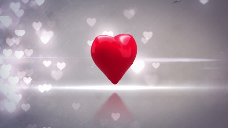 corazón rojo girando y explotando en un fondo brillante