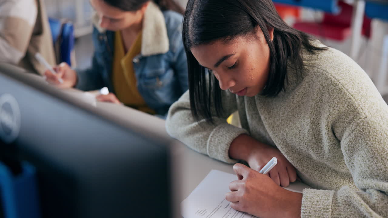 Students writing in a classroom