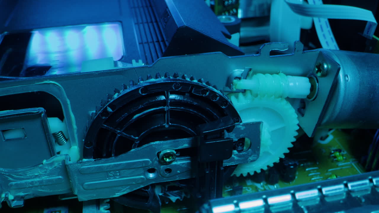 Old video recorder inside close-up, VHS. Retro player in neon blue light, vintage video cassette broadcasting, audio tape.