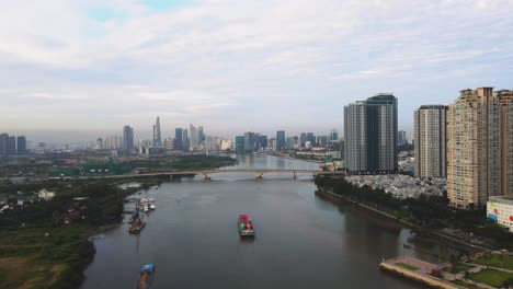 drone footage of saigon river in ho chi minh city with a cargo ship