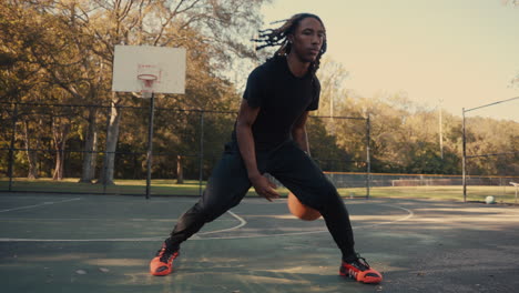 young man playing basketball outdoors