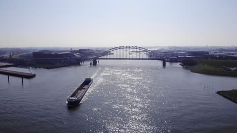 sunset scenery of boats cruising through the river noord in netherlands - aerial shot